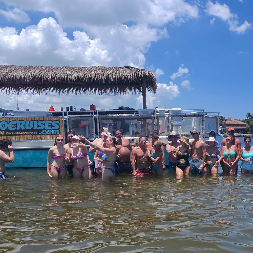 Guests swimming at a Fort Lauderdale sandbar next to the Tiki Taco boat